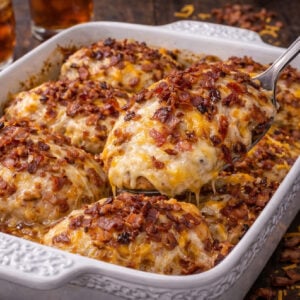 Four Cheese Bacon Stuffed Smothered Chicken Casserole in a white pretty baking dish