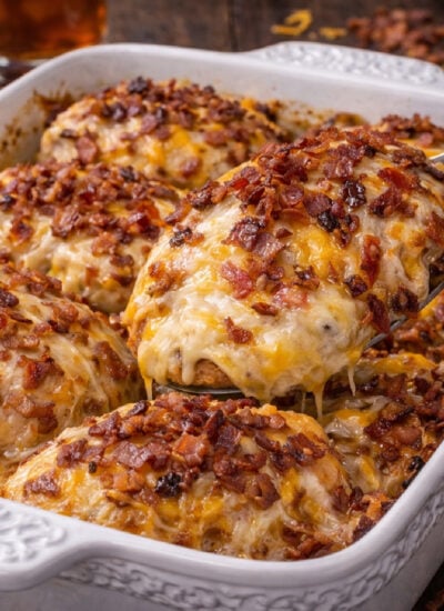 Four Cheese Bacon Stuffed Smothered Chicken Casserole in a white pretty baking dish
