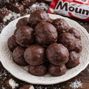 Mounds Coconut Copycat Chocolate Balls on a white pretty plate