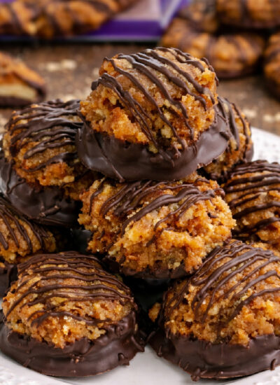 Samoa Bites on a white plate on a dark wood table