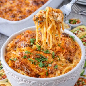 Cheesy Chicken Spaghetti with a fork lifting up a bite