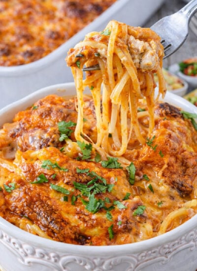 Cheesy Chicken Spaghetti with a fork lifting up a bite