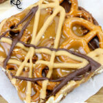 No Bake Caramel Pretzel Crack Bars on a white sheet