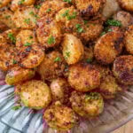 Crispy Garlic Parmesan Potatoes on a clear white plate