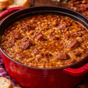 Ultimate Baked Beans with Smoked Sausage in a red pot