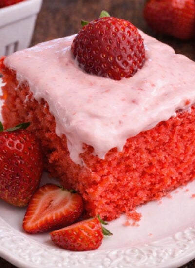 Strawberry Jello Cake with Strawberry Buttercream Frosting on a white plate