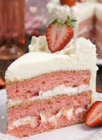 Strawberry Moscato Cake with Cream Cheese Buttercream Frosting on a white plate