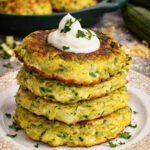 Cheesy Zucchini Pancakes on a pretty white plate
