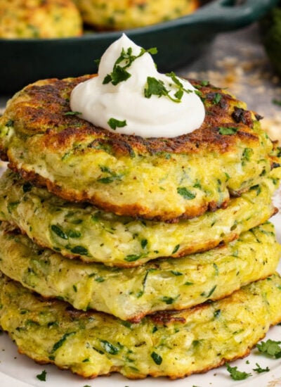 Cheesy Zucchini Pancakes on a pretty white plate