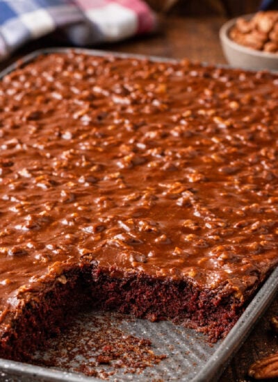 Texas Sheet Cake in a silver baking pan on a dark wood table