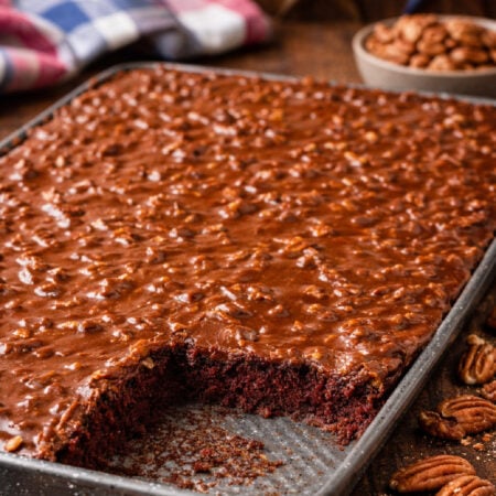 Texas Sheet Cake in a silver baking pan on a dark wood table