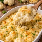 up close shot of the Cheesy Cauliflower Casserole with a spoon lifting up some