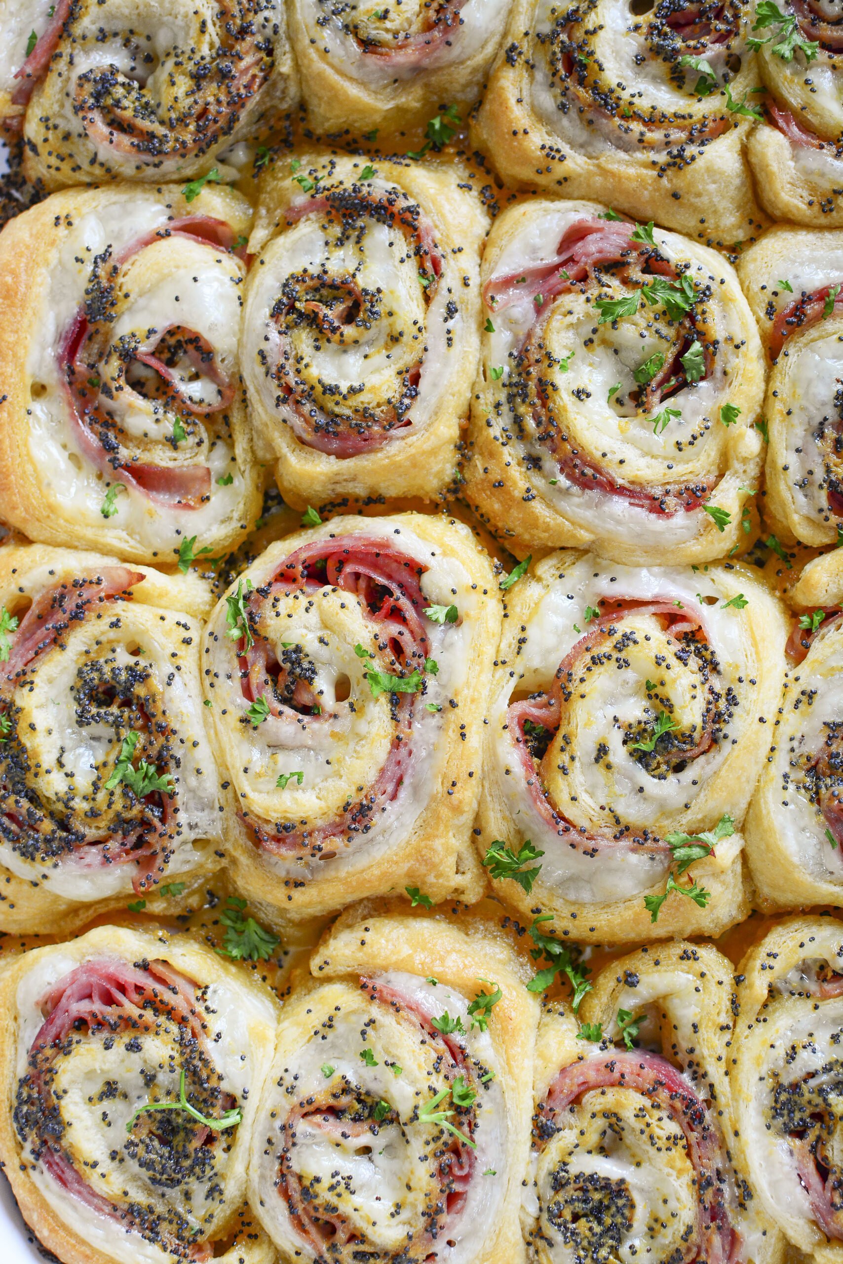 Ham and Cheese Pinwheels in a white baking dish overhead angle