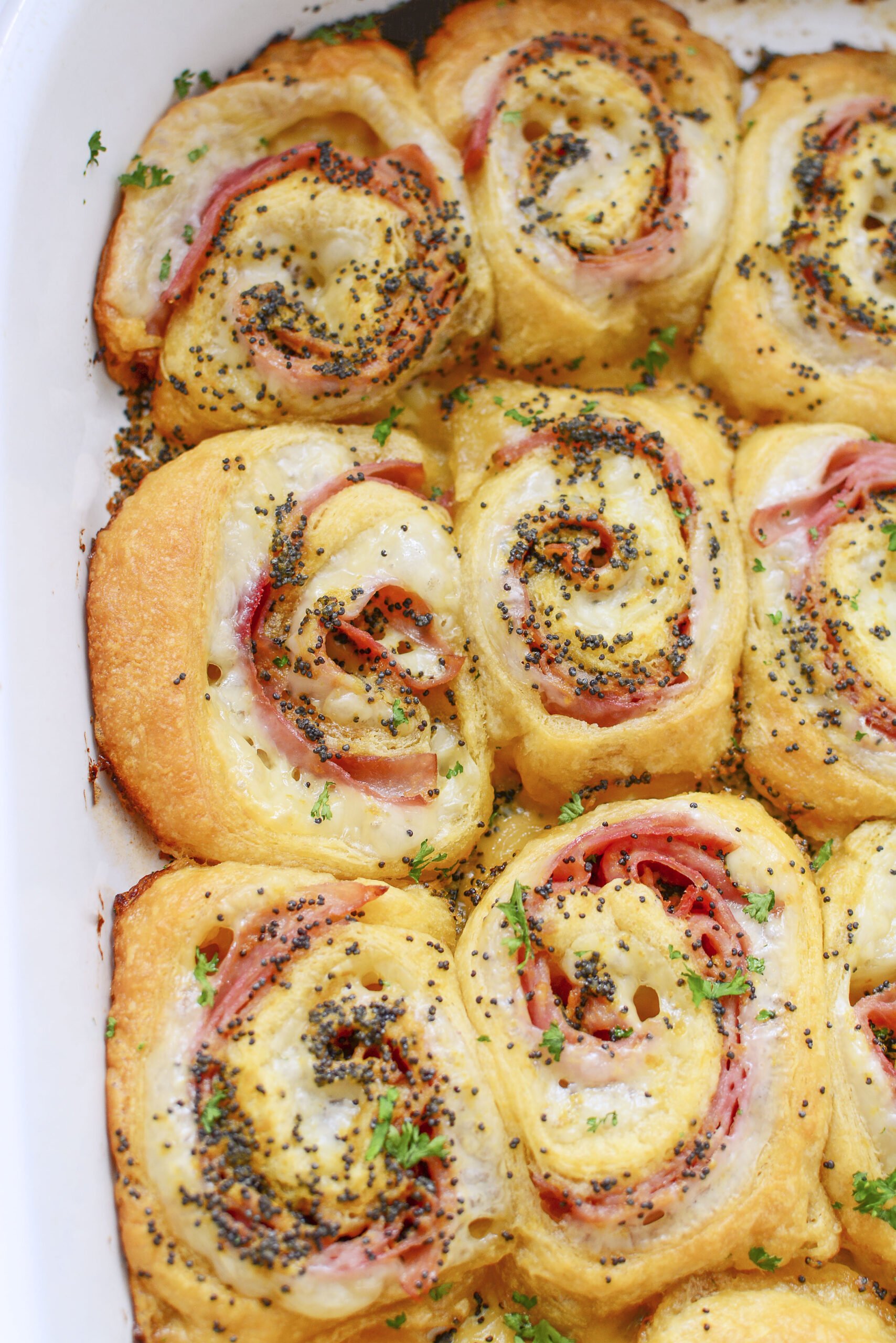 Ham and Cheese Pinwheels in a white baking dish overhead shot