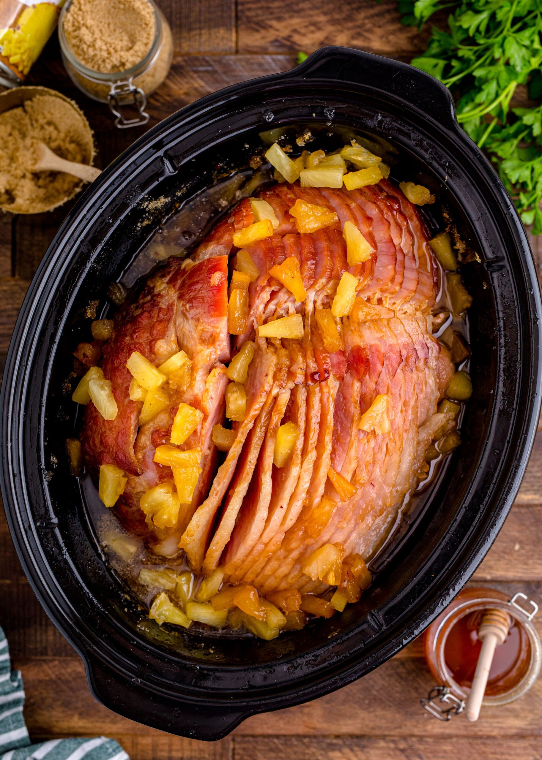 Crock Pot Brown Sugar Pineapple Ham in a black crock pot overhead shot