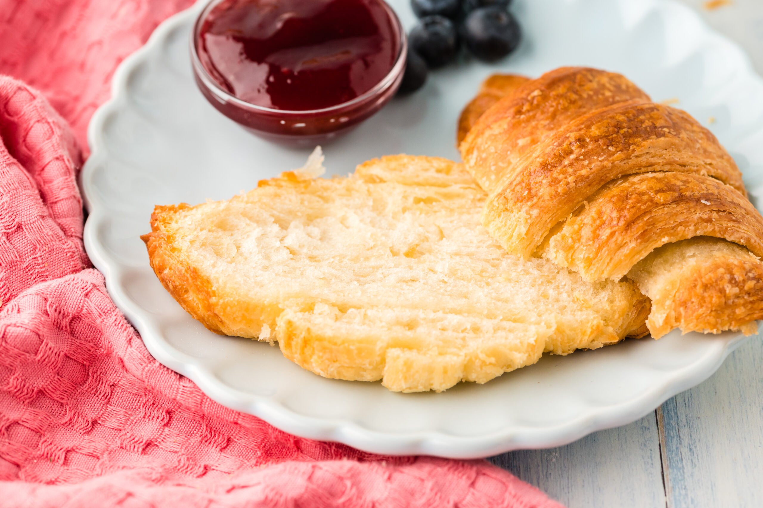 Croissants on a plate cut open to show the inside 