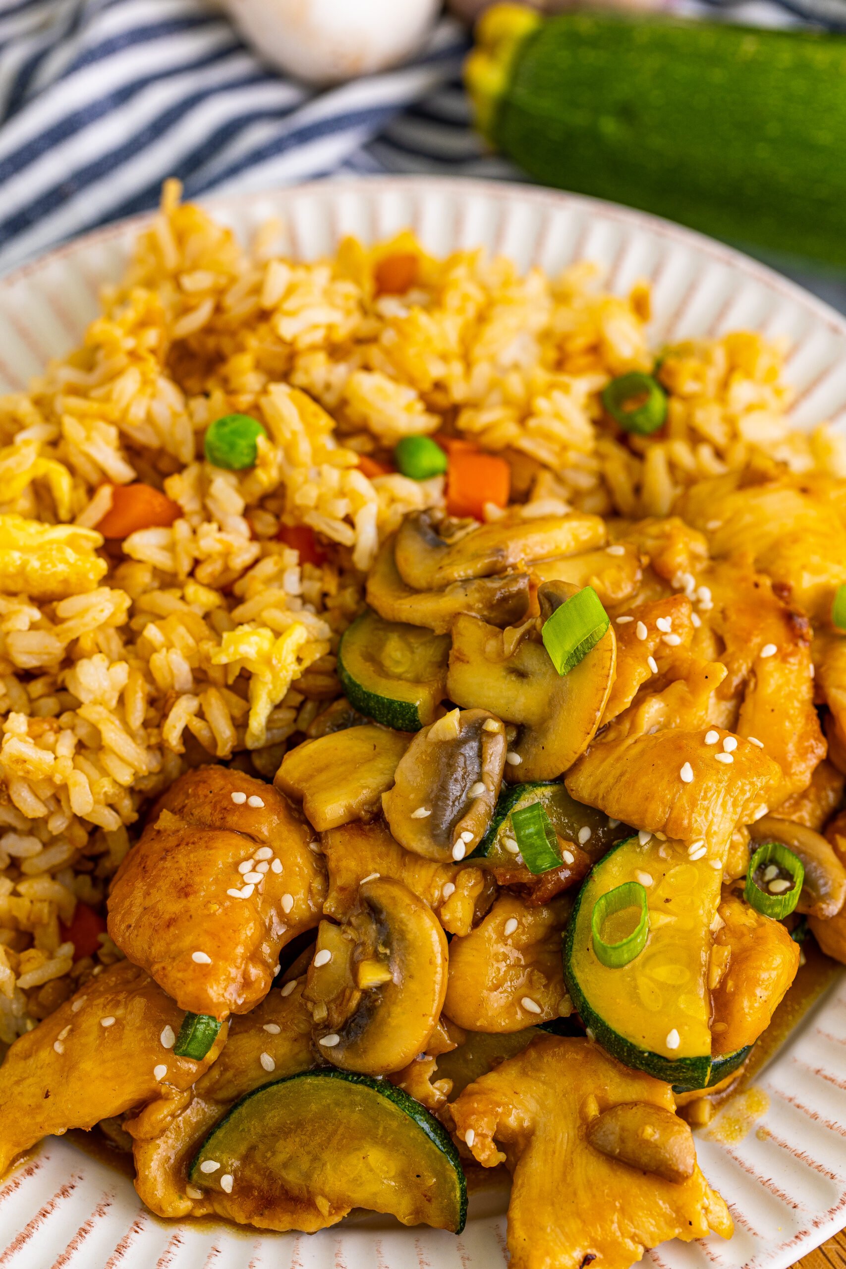 Panda Express Mushroom Chicken on a white plate with a side of fried rice