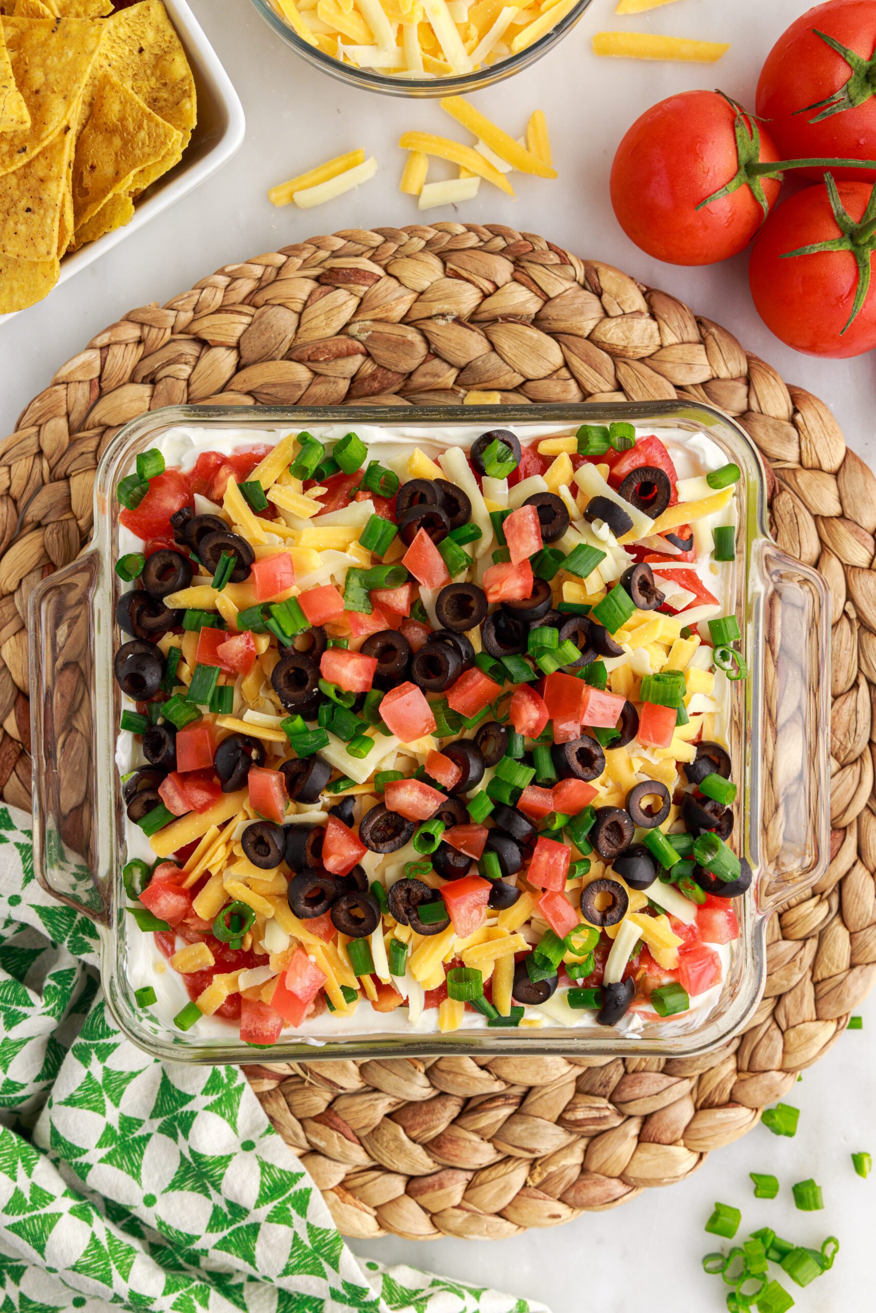 Overhead view of 7-Layer Dip in a clear baking dish.