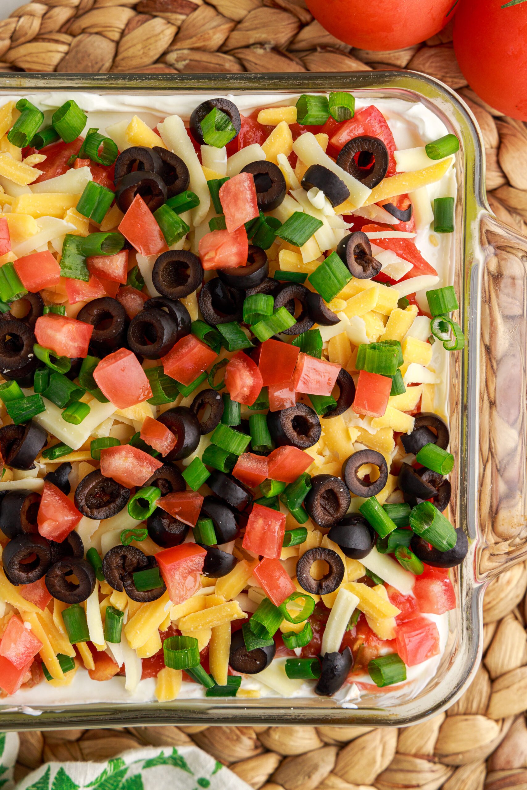 Overhead view of 7-Layer Dip in a clear baking dish.