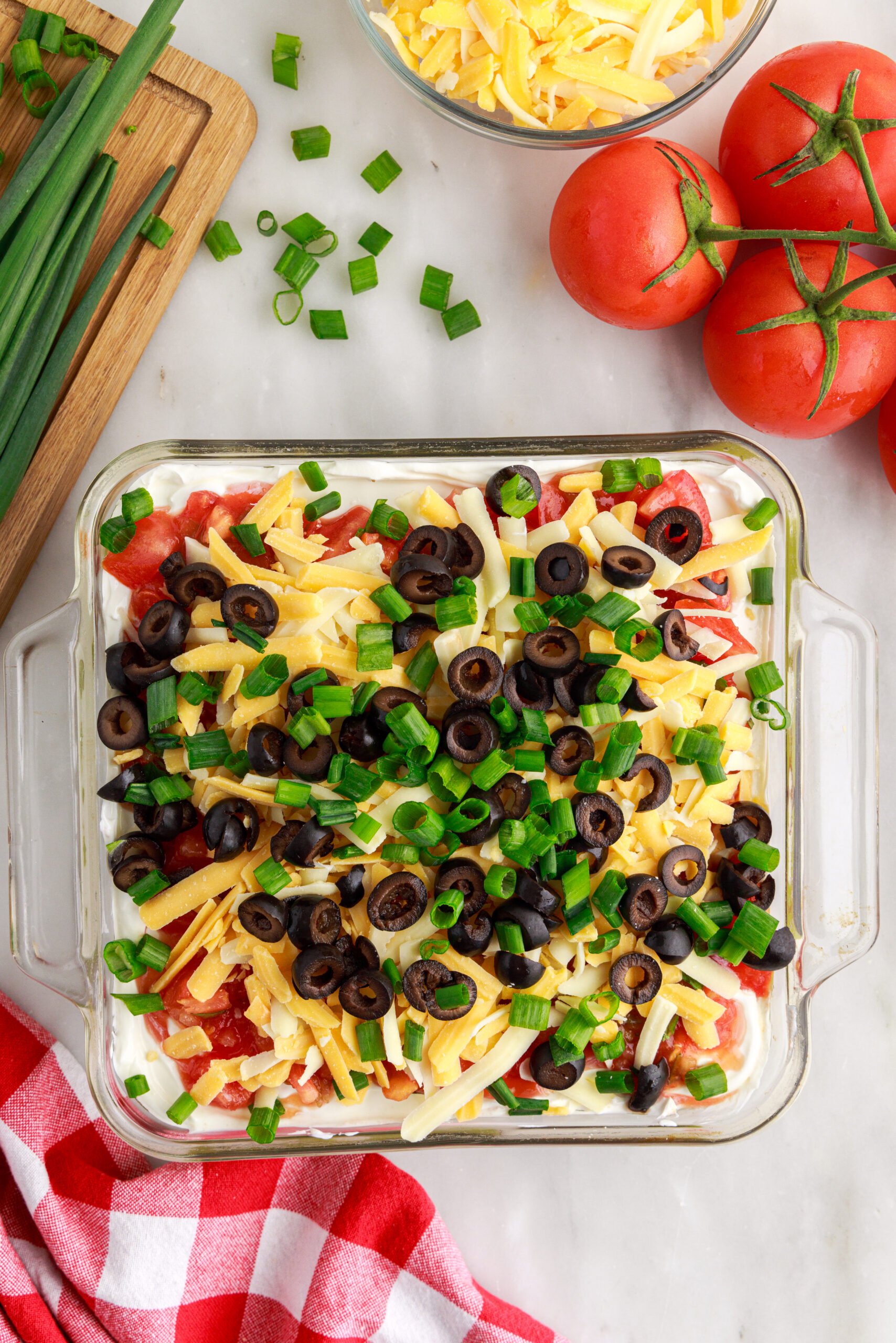 Overhead view of 7-Layer Dip in a clear baking dish.