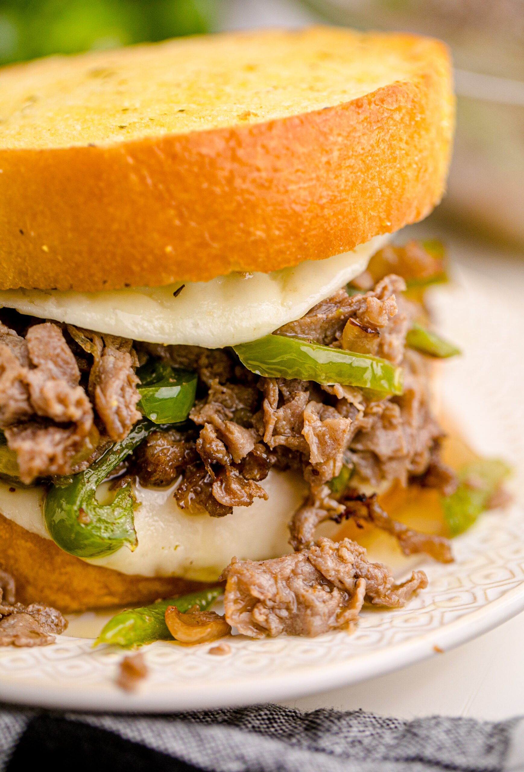 Up close view of Air Fryer Philly Cheese Steaks on a white plate.