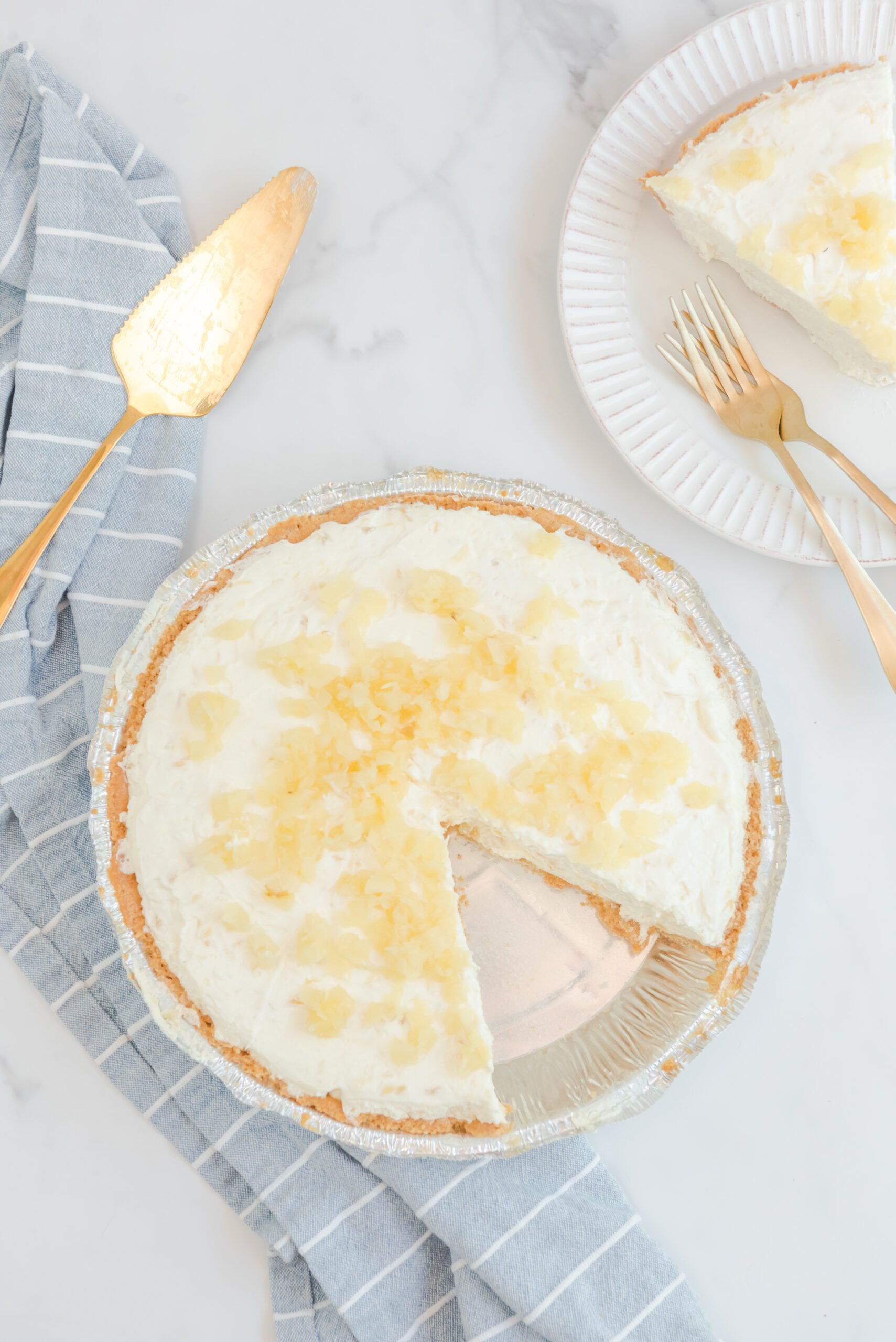 Overhead view of No Bake Pineapple Cheesecake with a slice removed.
