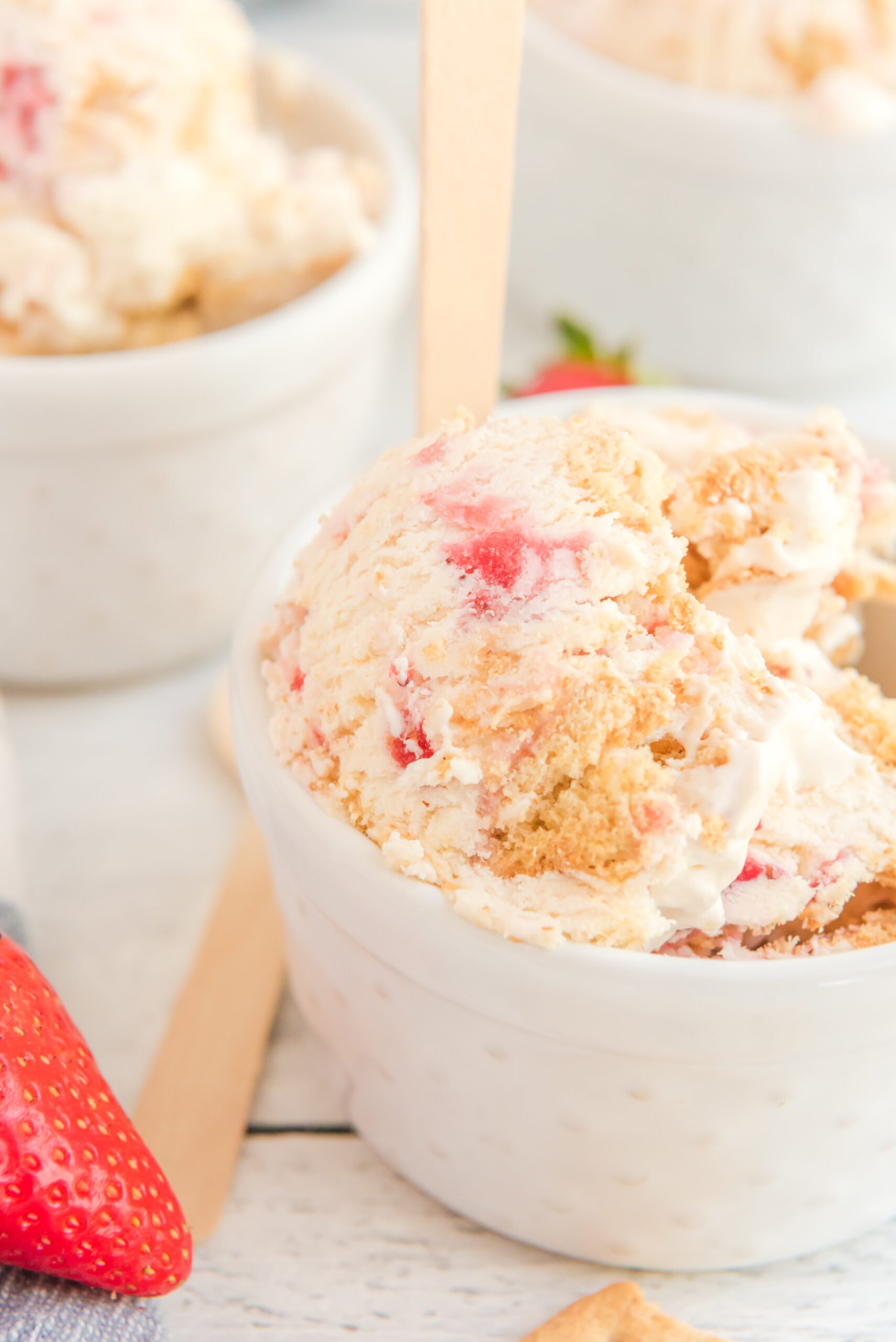 white bowl filled with Strawberry Cheesecake Ice Cream.