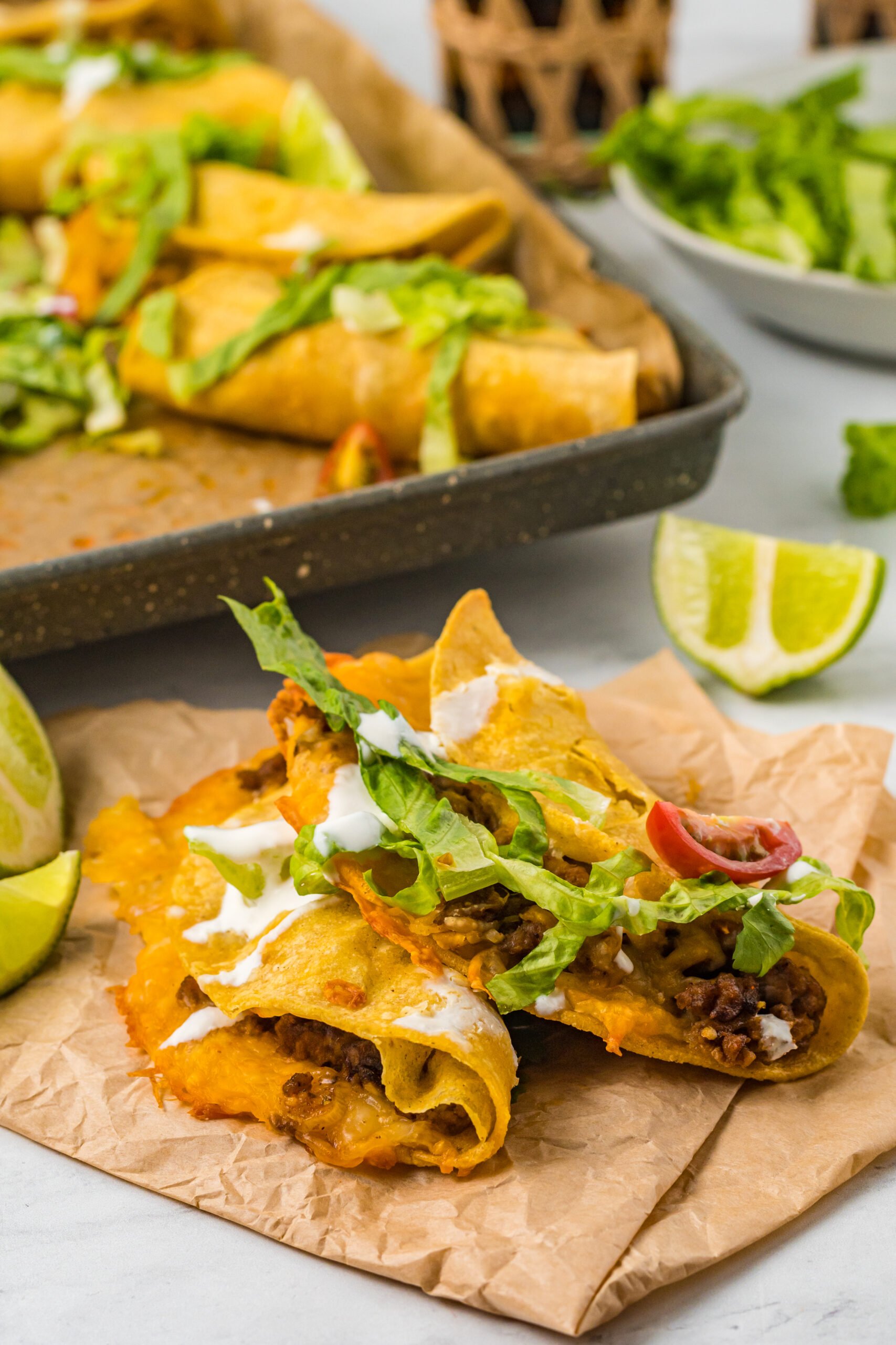 Front view of two Beef Tacos on parchment paper.