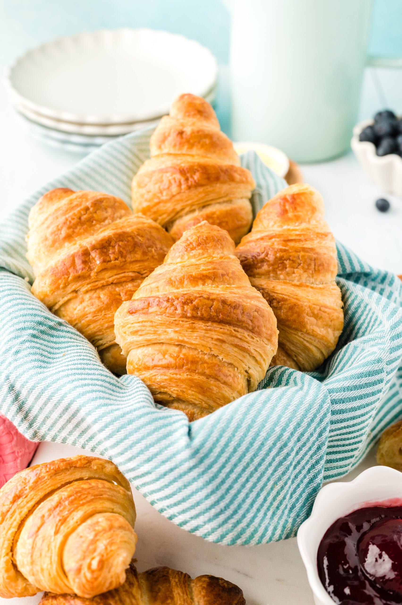 Front view of Homemade Croissants in a dish lined with linen.