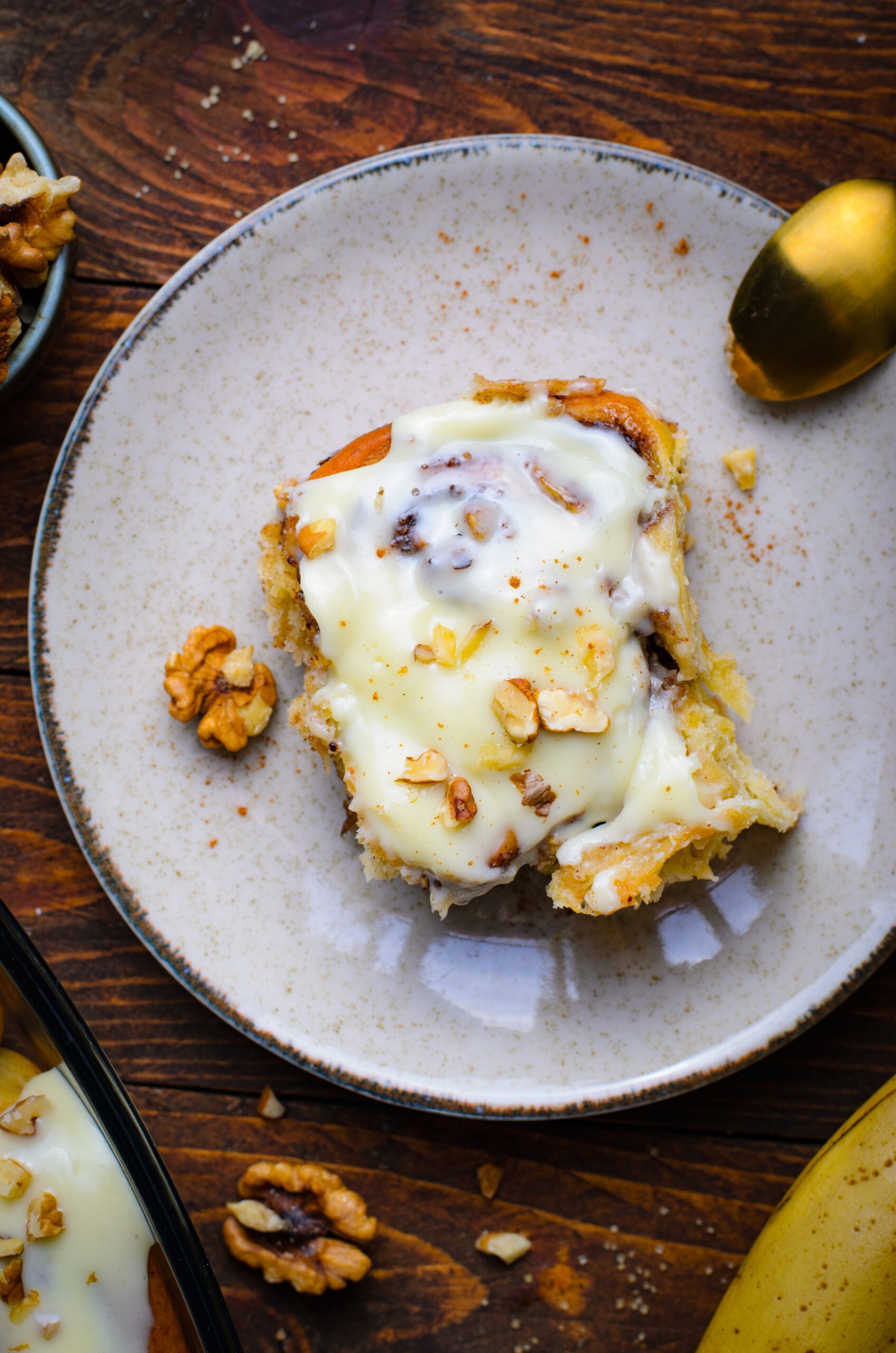 Overhead view of a Banana Nut Cinnamon Roll on a plate.
