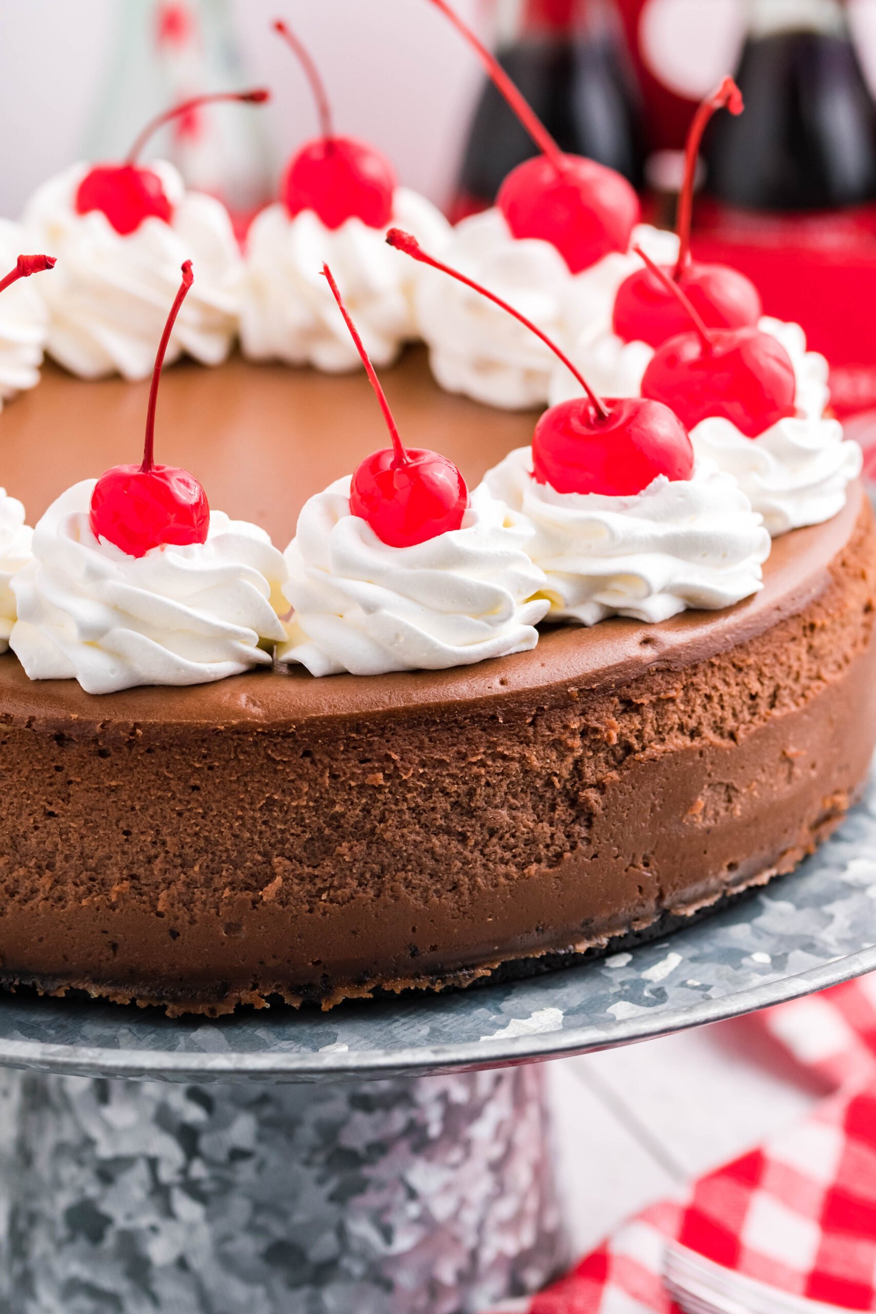 Up close side view of Coca Cola Cheesecake on a galvanized cake pan.