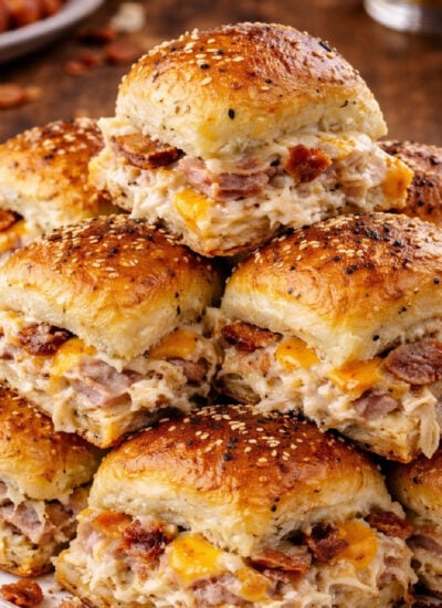 Crack Chicken Sliders stacked on a pretty white plate