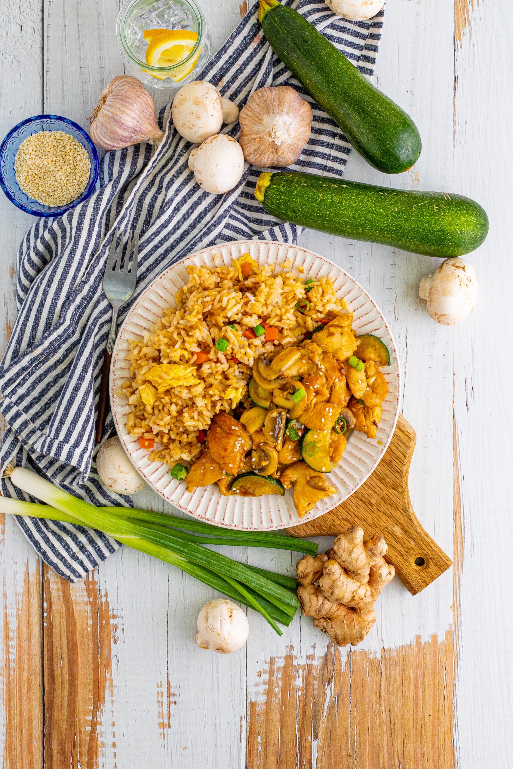 Overhead view of Panda Express Mushroom Chicken on a white dish served with fried rice.