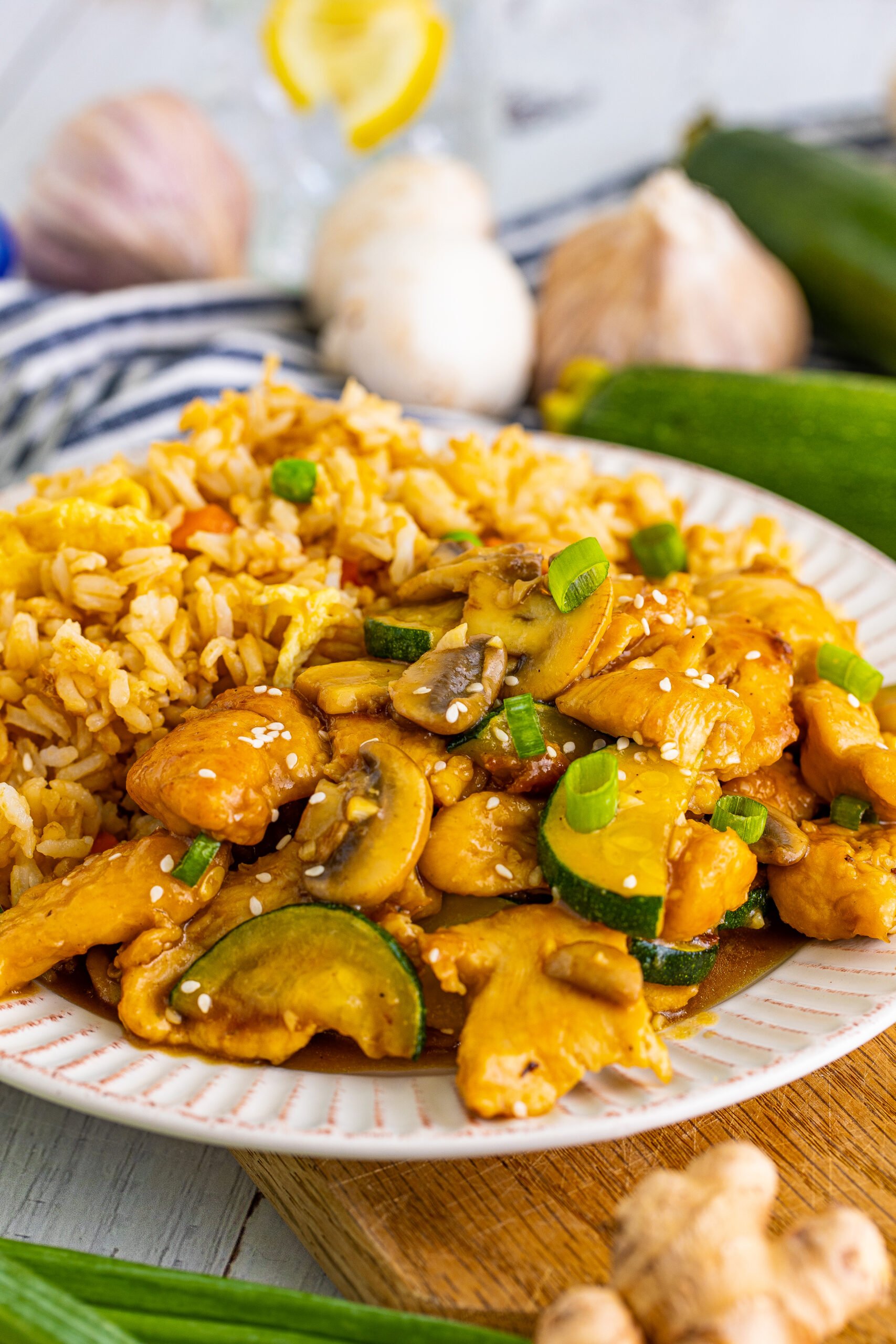 Close up view of Panda Express Mushroom Chicken on a white dish served with fried rice. 