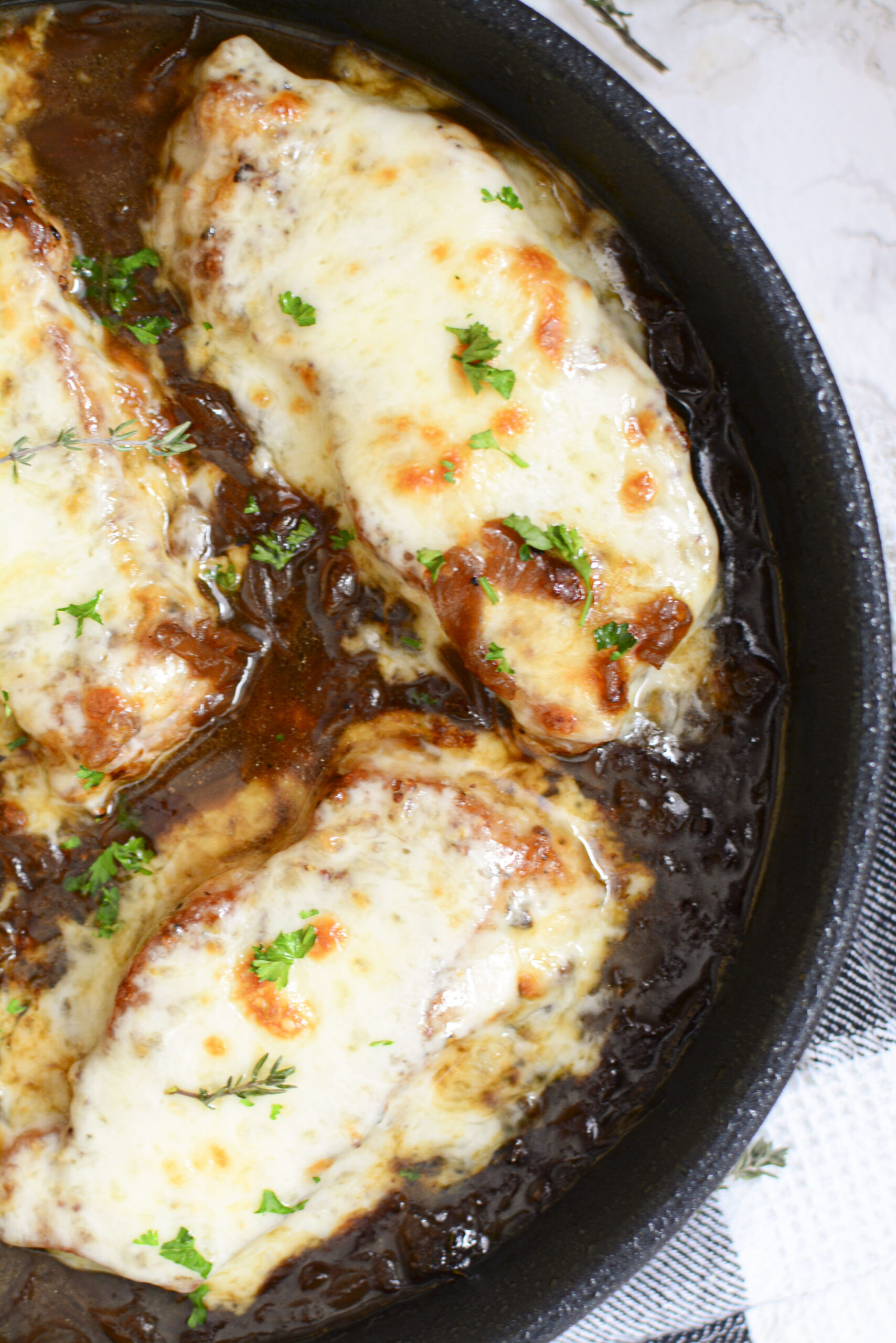 Overhead view of French Onion Pork Chops in a cast iron skillet.