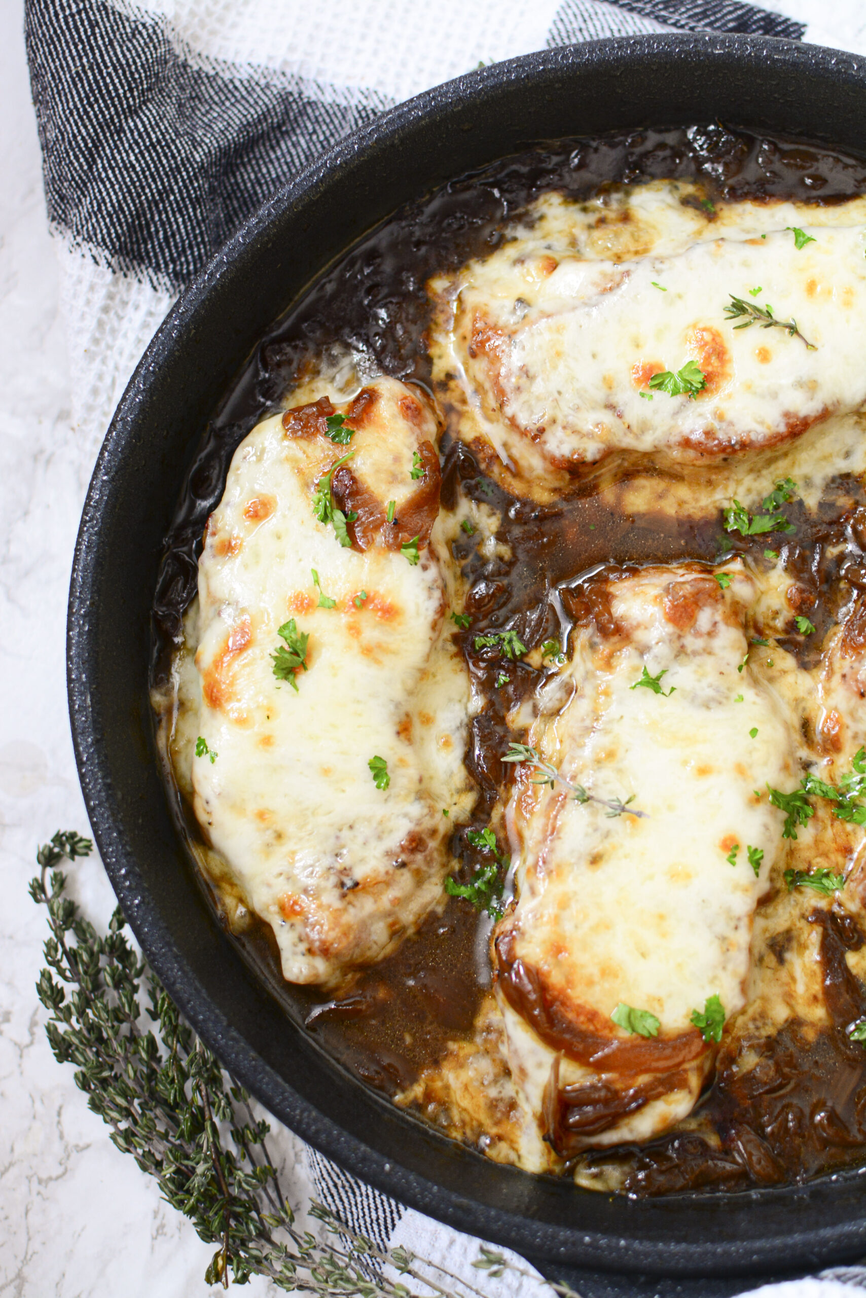 Overhead view of French Onion Pork Chops in a cast iron skillet.