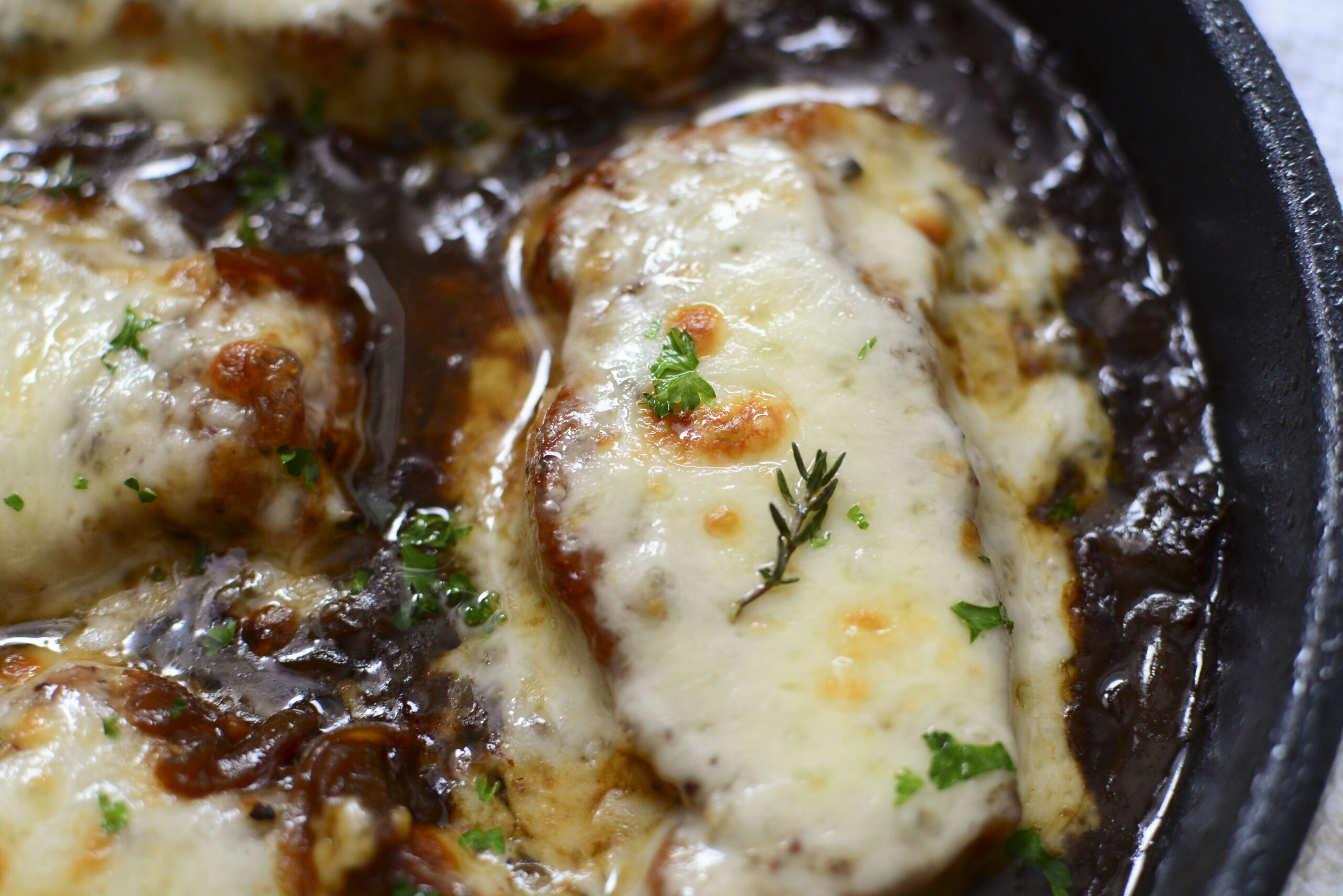 Overhead view of French Onion Pork Chops in a cast iron skillet.