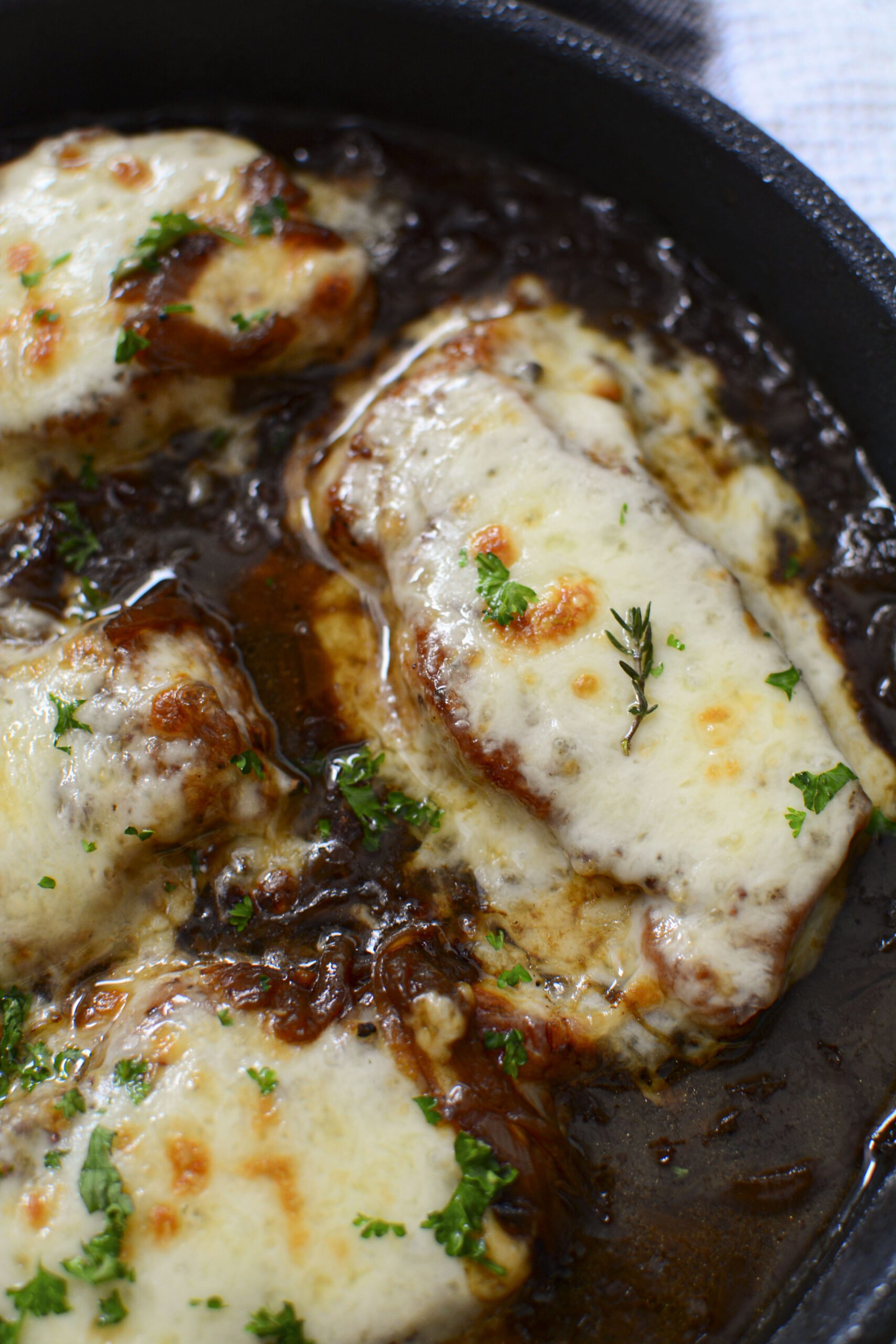 Overhead view of French Onion Pork Chops in a cast iron skillet.