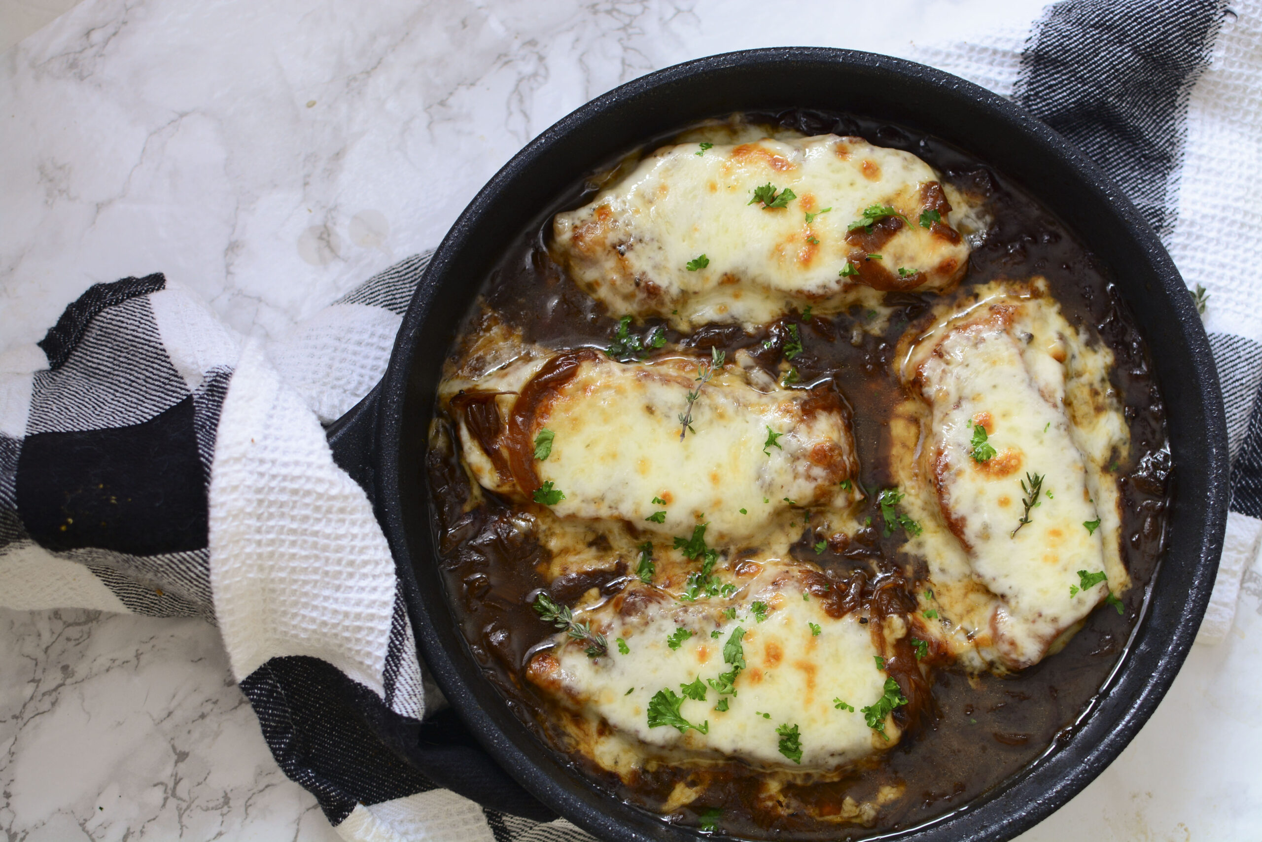 Overhead view of French Onion Pork Chops in a cast iron skillet.