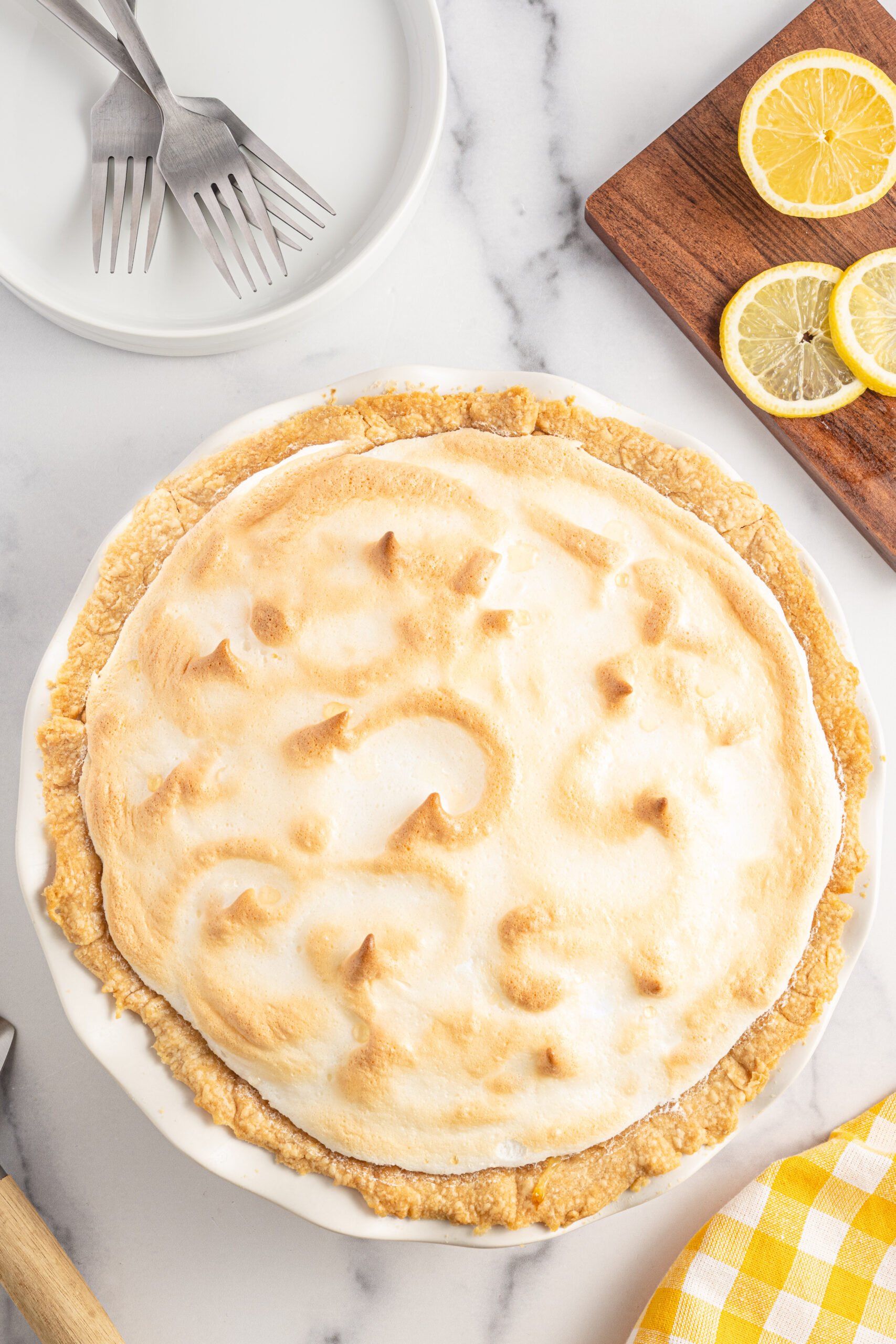Overhead shot of lemon meringue pie in a white pie dish. 