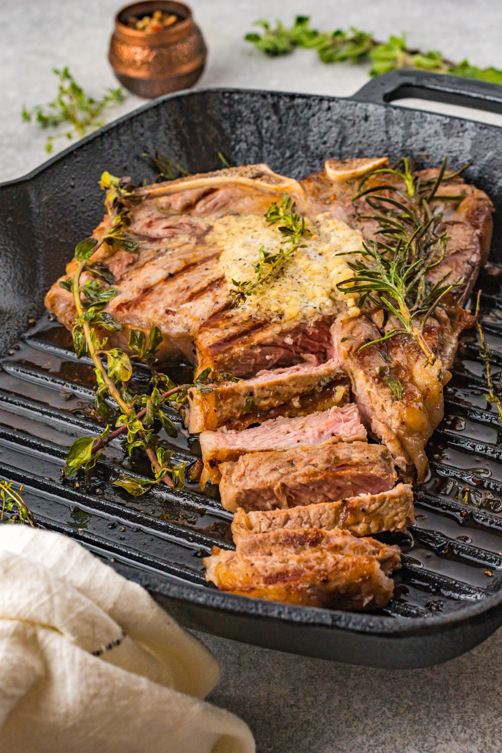 Front view of T Bone Steak in a cast iron skillet.