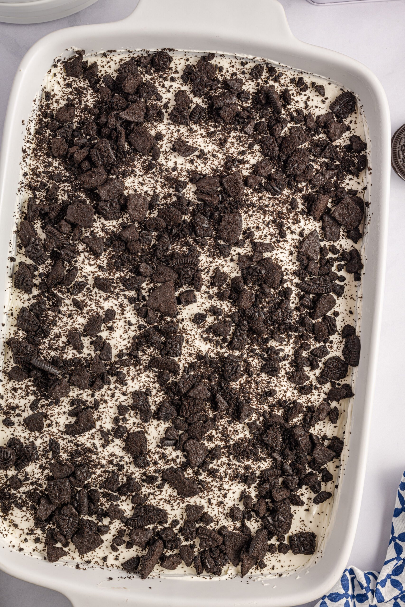 Overhead view of Oreo Icebox Cake in a white baking dish.