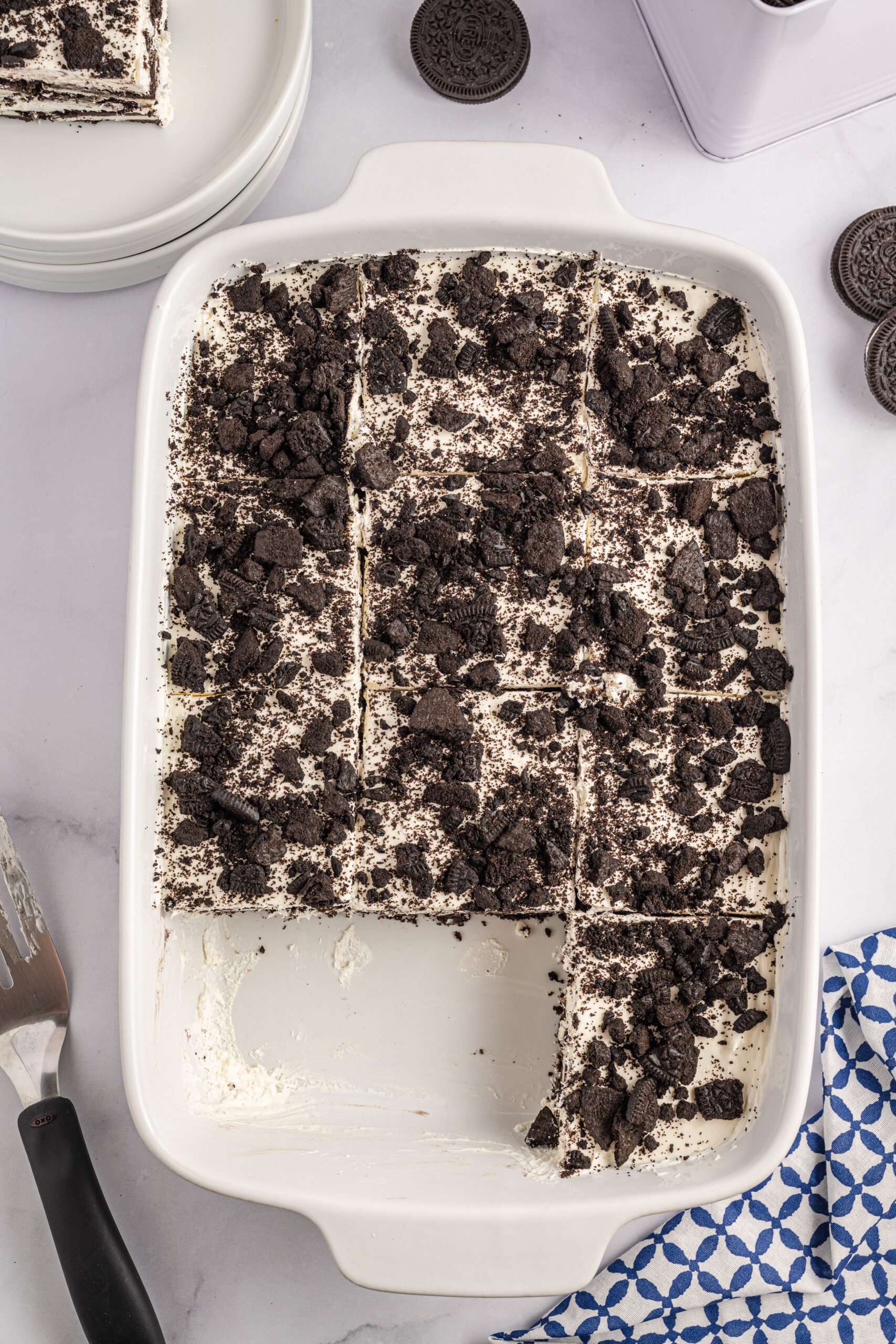 Overhead view of Oreo Icebox Cake, cut into slices, in a white baking dish.