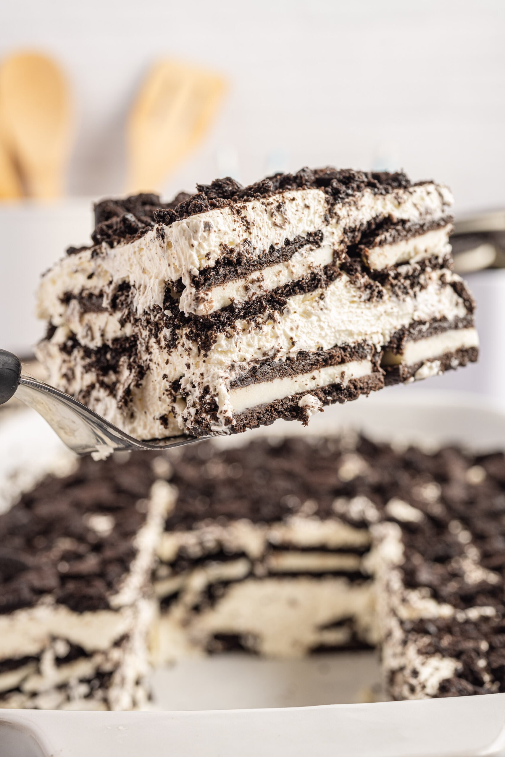 Front view of a slice of Oreo Icebox Cake on a silver cake server.