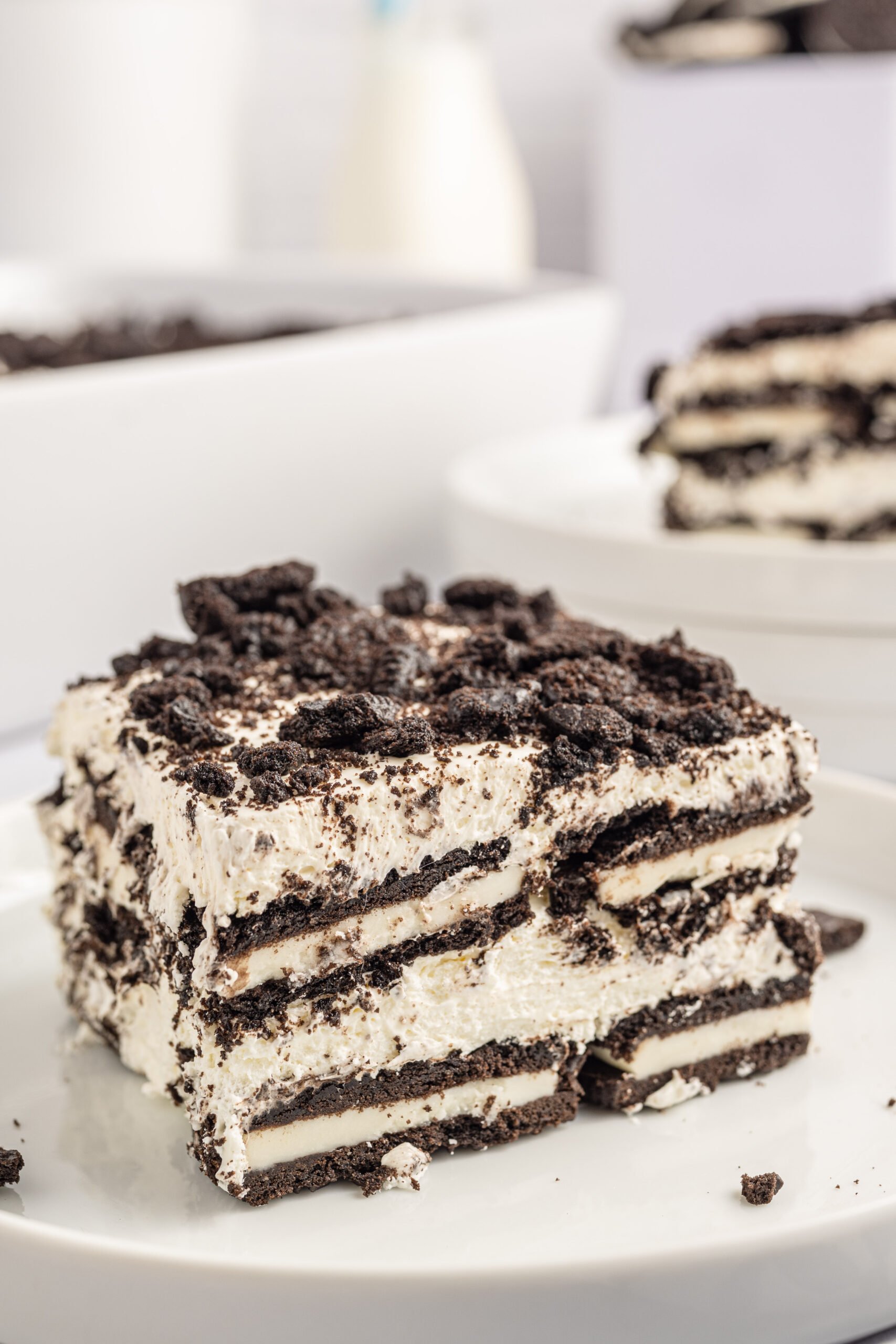 Front view of a slice of Oreo Icebox Cake on a white plate.