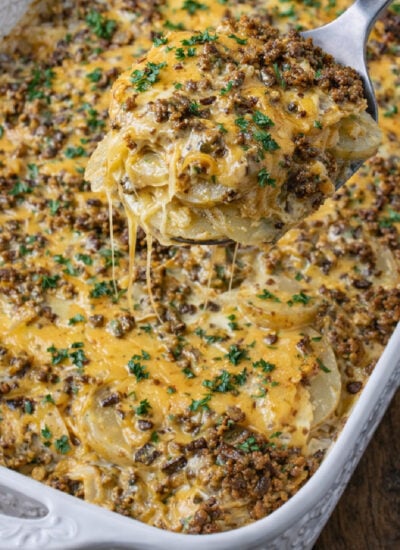 Cheesy Ground Beef & Potato Casserole in a white baking dish with a design