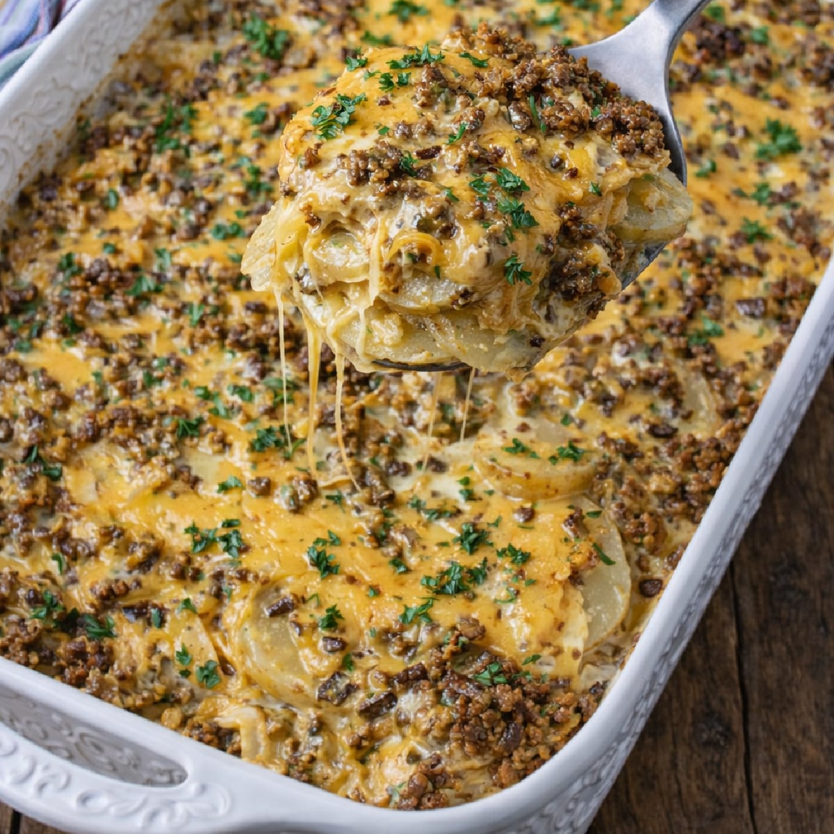 Cheesy Ground Beef & Potato Casserole in a white baking pan