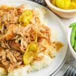 Slow Cooker Mississippi Chicken on plate with mashed potatoes