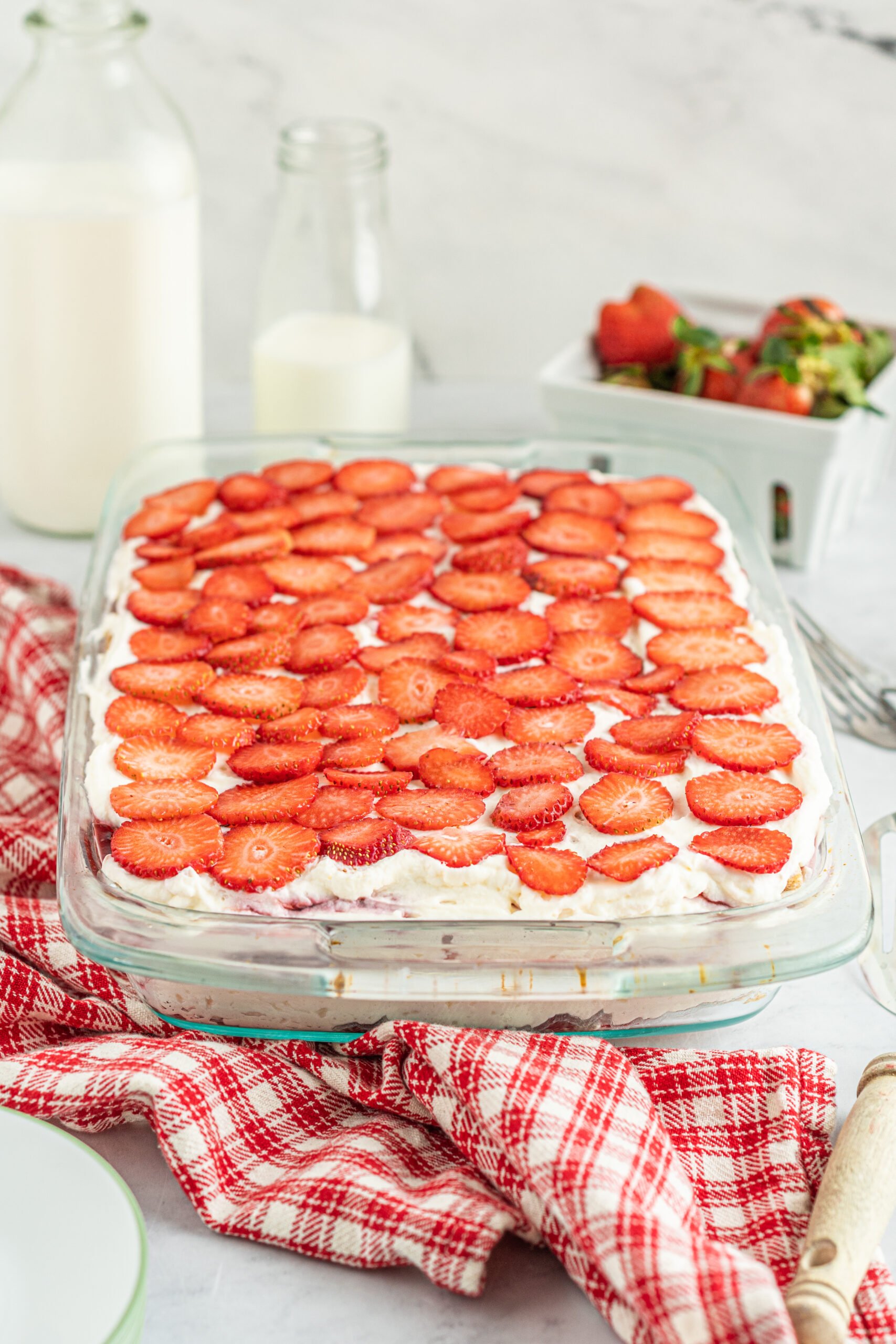 Side view of Strawberry Icebox Cake in a clear baking dish. 