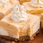 pumpkin cheesecake on table with bite taken out of slice